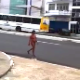 In this unbelievable video clip, a nude woman is observed walking along a busy street in a South American city. She stops, bends over, and takes a shit. Poop action is not visible at this distance. About a minute.